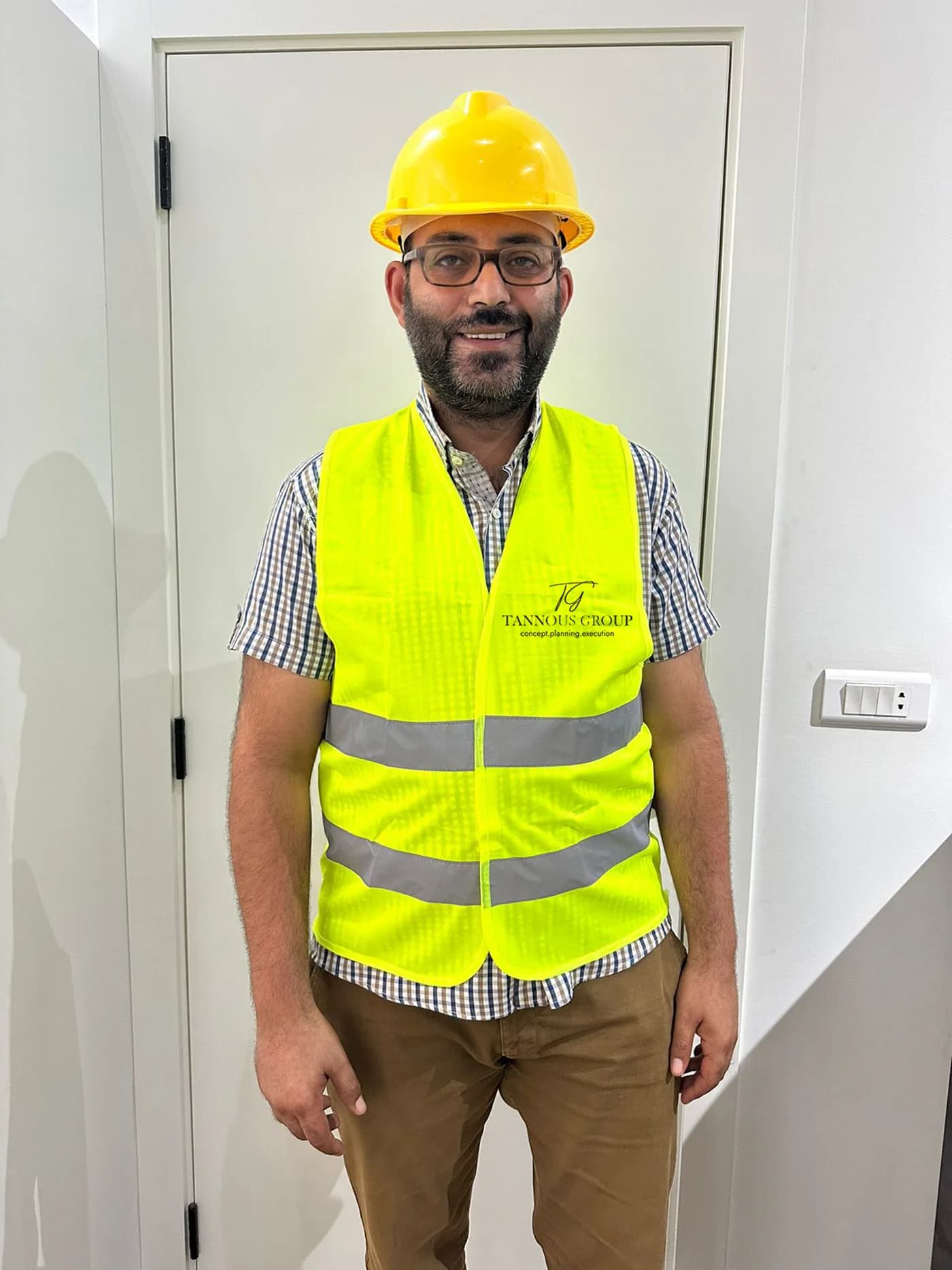 Branded Tannous Group high-visibility site vest, front